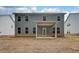 Exterior view of the home's back facade, showcasing the backyard, covered patio, and two stories at 251 Arnewood Cir, Mcdonough, GA 30253