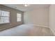 Bright bedroom featuring neutral walls, carpeted floors, and two windows for natural light at 251 Arnewood Cir, Mcdonough, GA 30253