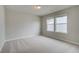 Neutral bedroom features neutral walls, carpeted floors, and a window for natural light at 251 Arnewood Cir, Mcdonough, GA 30253