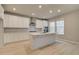 Well-lit kitchen featuring a center island, modern appliances, and ample cabinet space at 251 Arnewood Cir, Mcdonough, GA 30253