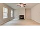 Bright living room with fireplace, ceiling fan, and large windows at 251 Arnewood Cir, Mcdonough, GA 30253