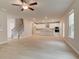 Open-concept living space leading to a kitchen and staircase at 251 Arnewood Cir, Mcdonough, GA 30253