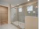 Modern glass shower features neutral tile, with a shower head, and is adjacent to the walk-in closet at 251 Arnewood Cir, Mcdonough, GA 30253
