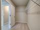 Small walk-in closet featuring carpeted flooring and wire shelving at 251 Arnewood Cir, Mcdonough, GA 30253