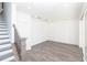 Bright, open-concept living area with sleek gray flooring and staircase access at 362 Olmstead Way # 23, Alpharetta, GA 30022