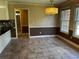Dining room features tile floors, classic wainscoting, neutral paint, and natural light at 512 Ollas Walk, Mcdonough, GA 30252
