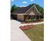 Charming home with a brick exterior, and well-manicured lawn, offering a delightful curb appeal at 512 Ollas Walk, Mcdonough, GA 30252