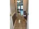 Hallway view leading to the kitchen, revealing tile flooring and neutral wall colors at 512 Ollas Walk, Mcdonough, GA 30252