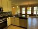 Modern kitchen featuring stainless steel appliances, dark countertops, and tile floors at 512 Ollas Walk, Mcdonough, GA 30252