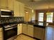 Modern kitchen featuring stainless steel appliances, dark countertops, and tile floors at 512 Ollas Walk, Mcdonough, GA 30252