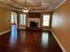 Bright and open living room with hardwood floors and a brick fireplace at 512 Ollas Walk, Mcdonough, GA 30252