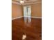 Living room with hardwood floors that open to an entry and other rooms at 512 Ollas Walk, Mcdonough, GA 30252