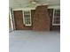 Covered brick patio area with a large brick fireplace, offering outdoor comfort and relaxation at 512 Ollas Walk, Mcdonough, GA 30252