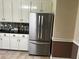 Stainless steel, french door refrigerator with cabinets, countertops, and backsplash at 512 Ollas Walk, Mcdonough, GA 30252