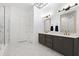 Bathroom with double vanities, modern fixtures, marble tile, and a glass-enclosed shower at 1103 Briar Cove Ne Cir, Atlanta, GA 30329