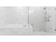 Bathroom with a soaking tub, glass-enclosed shower, and marble tile at 1103 Briar Cove Ne Cir, Atlanta, GA 30329