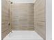Bathroom with tiled tub and shower featuring neutral design at 1103 Briar Cove Ne Cir, Atlanta, GA 30329