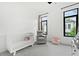 Bedroom featuring white crib, glider chair, and charming decor at 1103 Briar Cove Ne Cir, Atlanta, GA 30329