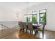 Dining room with modern chandelier, a dining table with seating for eight, and large windows at 1103 Briar Cove Ne Cir, Atlanta, GA 30329