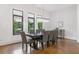 Dining room features hardwood floors, modern chandelier, large windows, and seating for eight at 1103 Briar Cove Ne Cir, Atlanta, GA 30329