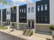Modern townhome with black and white facade, two stories, private garages, and landscaped entry at 1103 Briar Cove Ne Cir, Atlanta, GA 30329