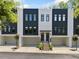 Modern townhome with black and white facade, two stories, private garages, and landscaped entry at 1103 Briar Cove Ne Cir, Atlanta, GA 30329