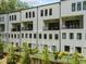Modern townhome exterior featuring balconies, black windows, and landscaped grounds at 1103 Briar Cove Ne Cir, Atlanta, GA 30329