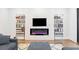 Bright living room featuring a fireplace with a TV, built-in bookshelves and hardwood floors at 1103 Briar Cove Ne Cir, Atlanta, GA 30329