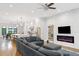 Open-concept living room with a fireplace, television, large grey sofa, and view to the kitchen at 1103 Briar Cove Ne Cir, Atlanta, GA 30329
