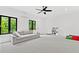 Spacious living room featuring a comfortable sofa, large windows, and ample room for activities at 1103 Briar Cove Ne Cir, Atlanta, GA 30329