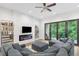 Modern living room features a fireplace, television, and large glass doors to the backyard at 1103 Briar Cove Ne Cir, Atlanta, GA 30329