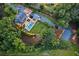 Aerial view of estate featuring lush landscaping, a pool, and a long driveway to the main residence at 150 Trinity Farm Dr, Canton, GA 30115