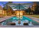 Relaxing backyard pool with an outdoor kitchen, lounge chairs, and lush landscaping for ultimate comfort and style at 150 Trinity Farm Dr, Canton, GA 30115