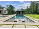 Relaxing backyard retreat featuring a sparkling pool, outdoor lounging, and a covered outdoor kitchen at 150 Trinity Farm Dr, Canton, GA 30115