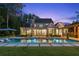 Gorgeous backyard with a pool, an outdoor kitchen, and lush landscaping, perfect for relaxation and entertainment at 150 Trinity Farm Dr, Canton, GA 30115