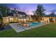 Stunning backyard pool with a lounge area, an outdoor kitchen and lush landscaping, perfect for entertaining at 150 Trinity Farm Dr, Canton, GA 30115