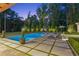 Beautiful backyard pool with lounge chairs and manicured landscaping, creating a private oasis at 150 Trinity Farm Dr, Canton, GA 30115