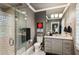 Bathroom with a glass enclosed shower, gray vanity, and a decorative mirror at 150 Trinity Farm Dr, Canton, GA 30115