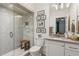 Elegant bathroom with mosaic shower tiles, white vanity, and framed artwork at 150 Trinity Farm Dr, Canton, GA 30115