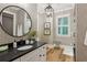 Elegant bathroom featuring a round mirror, patterned walls, and modern lighting at 150 Trinity Farm Dr, Canton, GA 30115