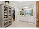 Bright bathroom with double vanity, custom cabinets, and decorative tile floor at 150 Trinity Farm Dr, Canton, GA 30115