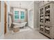 Stylish bathroom features soaking tub, walk-in shower, and linen cabinet at 150 Trinity Farm Dr, Canton, GA 30115