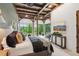 Beautiful bedroom featuring exposed beams, a large picture window with backyard views, and a nearby staircase at 150 Trinity Farm Dr, Canton, GA 30115