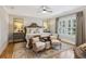 Bright bedroom featuring shuttered windows, and two cushioned chairs at 150 Trinity Farm Dr, Canton, GA 30115