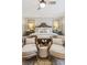 Bright bedroom featuring shuttered windows, cushioned chairs, and ceiling fan at 150 Trinity Farm Dr, Canton, GA 30115