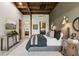 Well-lit bedroom boasts exposed beams, an ensuite bathroom/laundry, and large picture windows with pleasant backyard views at 150 Trinity Farm Dr, Canton, GA 30115