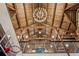 View of basketball court ceiling with wood beams, chandelier, and upper level balcony at 150 Trinity Farm Dr, Canton, GA 30115