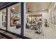 Cozy covered patio with a fireplace, comfortable seating, and large windows overlooking the beautiful outdoors at 150 Trinity Farm Dr, Canton, GA 30115
