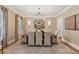 Formal dining room with neutral wallpaper, chandelier, and large table at 150 Trinity Farm Dr, Canton, GA 30115