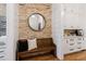 Cozy entryway with brick wall accent, wooden bench and storage at 150 Trinity Farm Dr, Canton, GA 30115